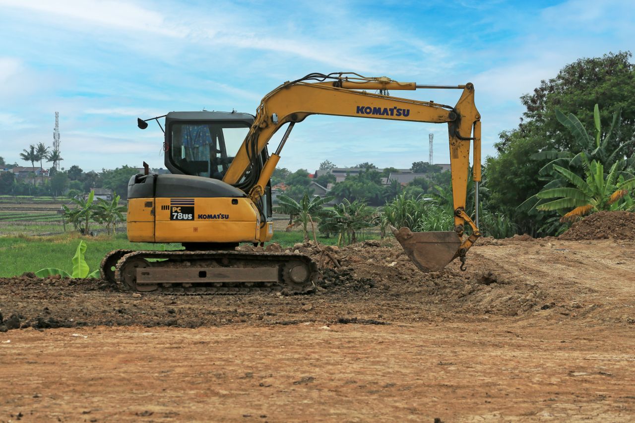 Mastering the First Impression: Your intriguing post title goes here Yellow excavator on a rural construction site on a sunny day.